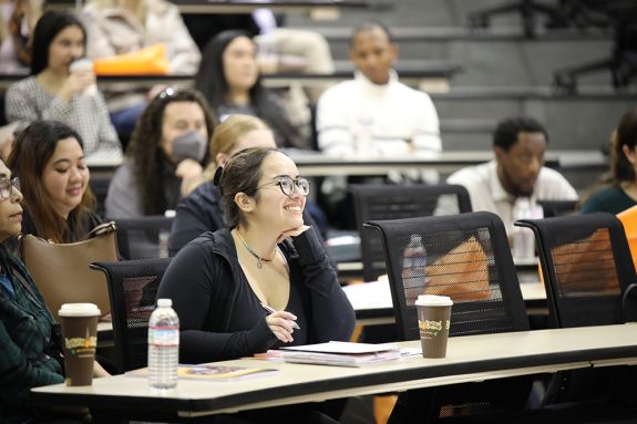 Photo of a student in a lecture hall.