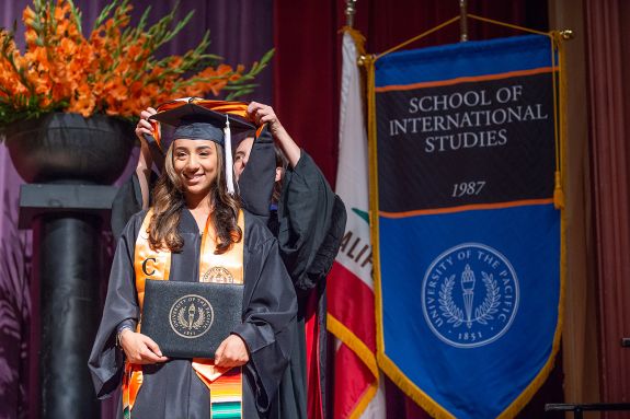 Graduated being hooded at the commencement ceremony.