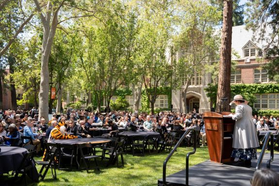faculty and staff sitting at tables on Knoles Lawn
