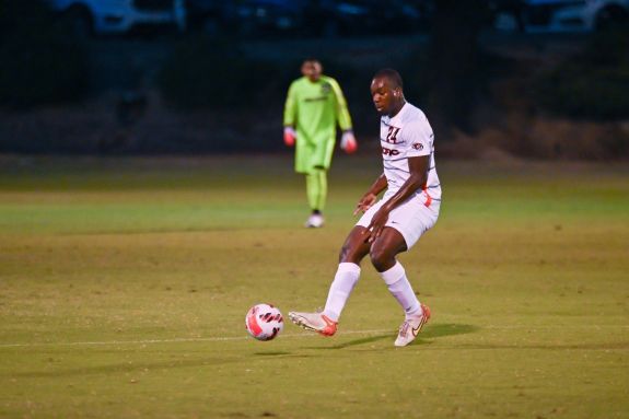 Soccer player passes the ball.