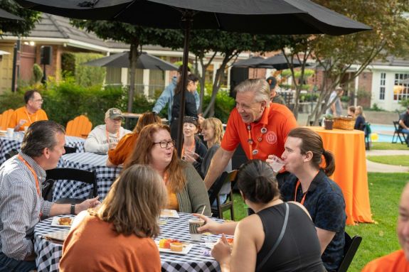 President visiting with families in backyard