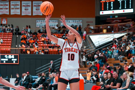 Women's basketball player shooting the ball