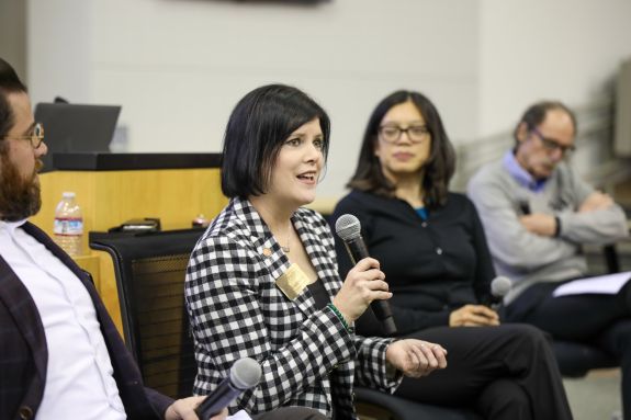A woman speaks into a microphone