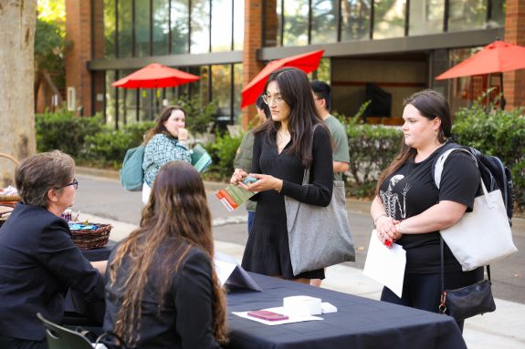 two student at a table booth or a job fair