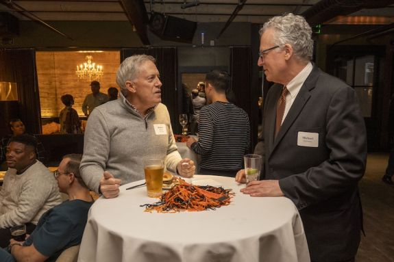 Two gentlemen talking to each other 