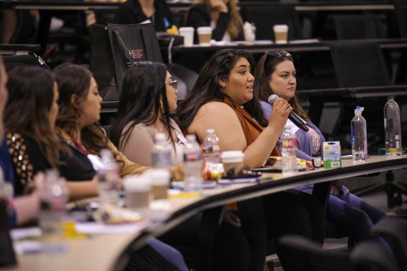 audience members speaking into a mic