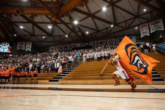Powercat with flag running through AG Spanos Center 
