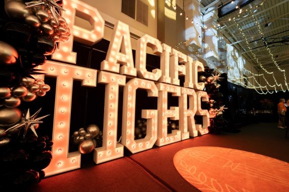 pacific tigers in giant marquee letters with balloons and the seal rug
