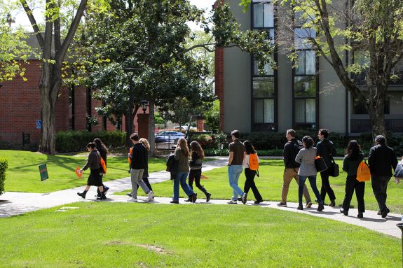 Group of people touring a campus. 