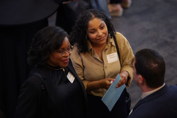 Aerial view of students speaking with an employer.