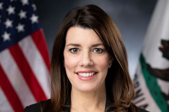 A portrait of a woman in front of US flag