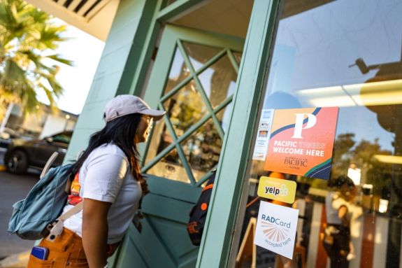 a student walks into a store on the Miracle Mile