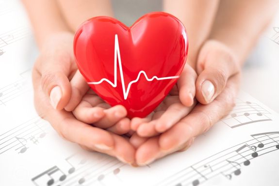 beating heart with held by human hands