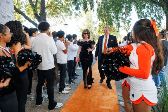 Couple walks the orange carpet into Orange & Black