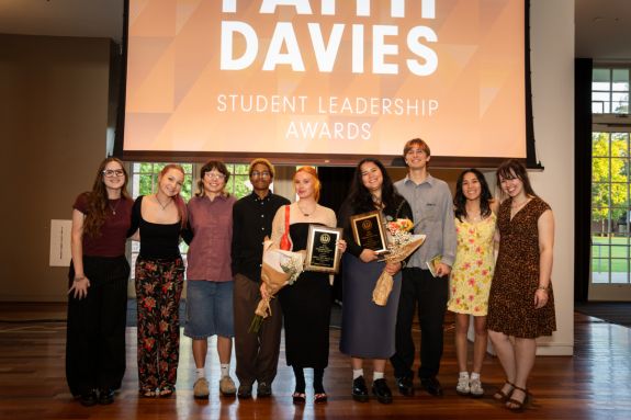 students posing with their faith davies awards in the derosa university center ballroom
