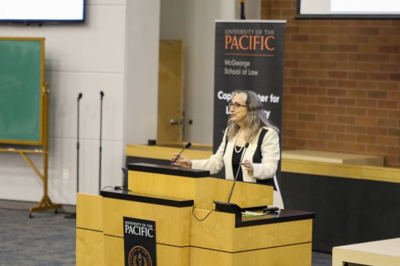 A professor speaks at a podium