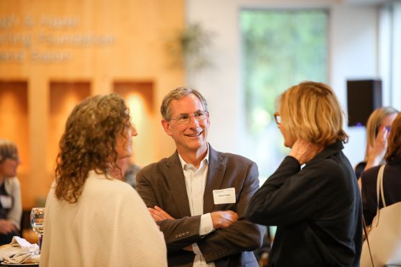 Attendees speaking with each other.