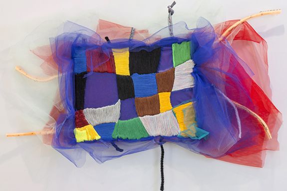 Colorful embroidered rectangle with tulle fluffs on the side