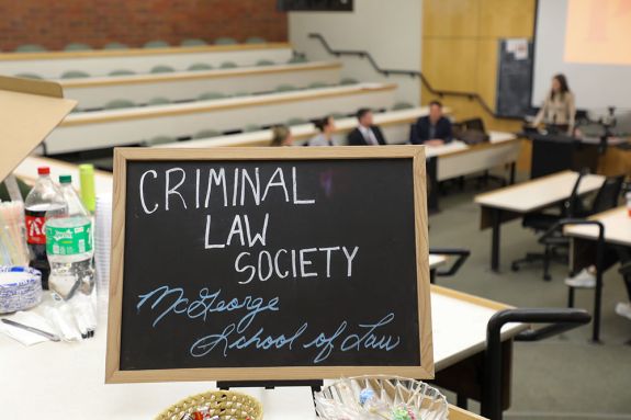 A chalkboard sign that says "Criminal Law Society"