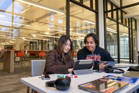 two students studying in library 