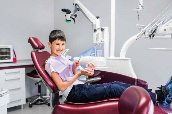 smiling young person in dental chair
