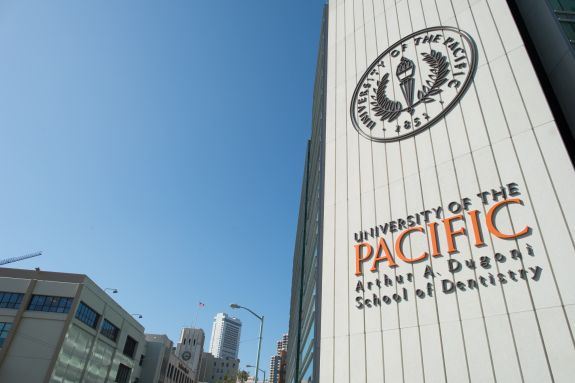 Dental School's logo on the outside of the building