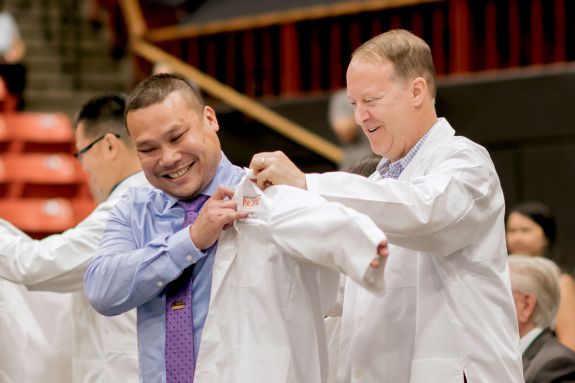 PharmD student with faculty member at White Coat Ceremony
