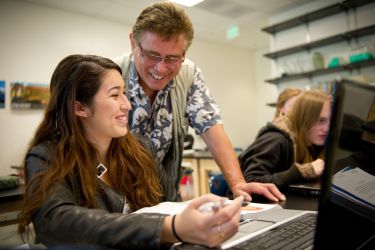 Professor Tenaza helping a student
