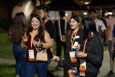 Three women walking with drinks