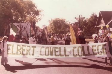 Archive photo of students holding Elbert Covell College banner