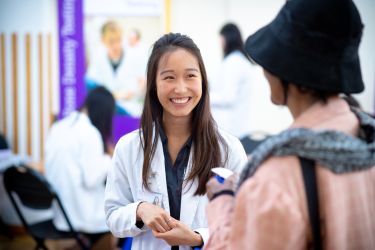 Pharmacy student welcoming patient.
