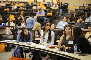 students listen in on an info session