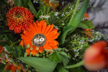 50th reunion pin in an orange flower.