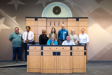 A group of people at the courthouse pose for a photo 