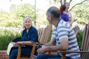 Parents talking outside of the DeRosa University Center in lawn chairs