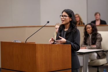 A student argues a case in a courtroom