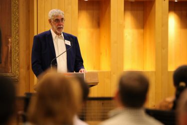 A man speaks at a podium