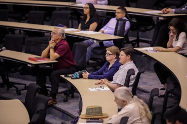 Audience listening intently.