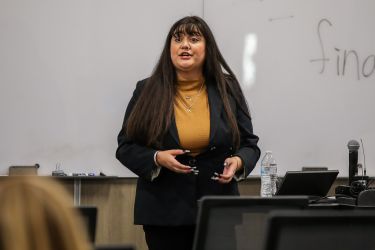 Presenter giving a lecture to audience.