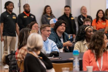 students attending orientation sitting at tables