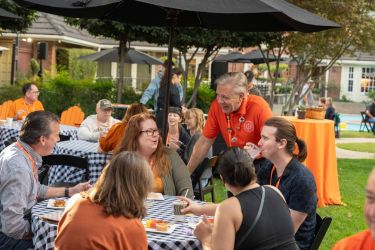 President socializing with a family in backyard