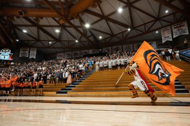 Powercat with flag running through AG Spanos Center 