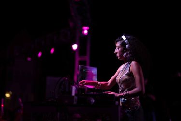 student djing with purple lights