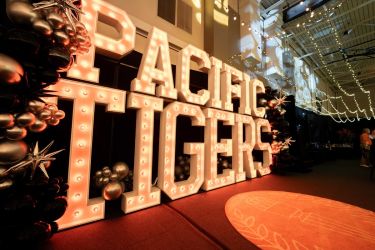 pacific tigers in giant marquee letters with balloons and the seal rug