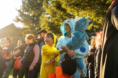 family dressed up in costumes on DUC lawn