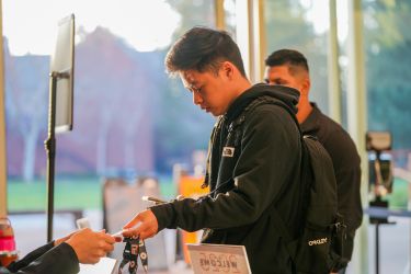 student checking in at derosa university center