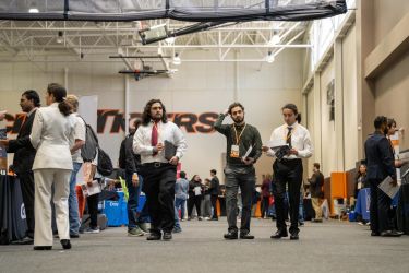 Students walking past booths at Career Expo