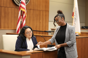 A student argues a case in a courtroom