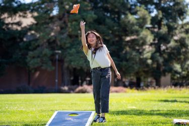 student playing cornhole