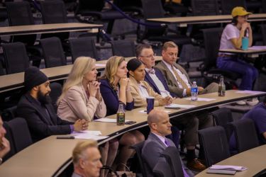 Students participating in a presentation by employers.